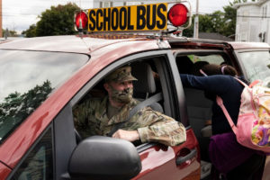 National Guard soldier Richard Gibbs transports students to and from middle school at Morris H. Seigal Clark Avenue School in Chelsea, Mass. on Sept. 30.